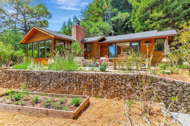 3 Wainwright Pl, Mill Valley, CA 94941 - back of property with a chimney, a vegetable garden, a sunroom, and roof with shingles