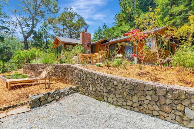 3 Wainwright Pl, Mill Valley, CA 94941 - view of home's exterior featuring a chimney, a vegetable garden, and a patio area