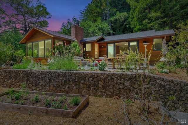 3 Wainwright Pl, Mill Valley, CA 94941 - back of house with a chimney, a garden, a sunroom, and roof with shingles