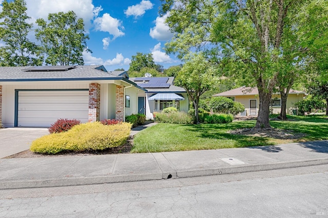 326 Stone Creek Cir, Santa Rosa, CA 95409 - view of front of house featuring a front lawn, driveway, an attached garage, and solar panels