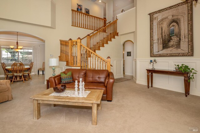 230 Clear Ridge Dr, Healdsburg, CA 95448 - living area with arched walkways, carpet floors, stairs, a towering ceiling, and a chandelier
