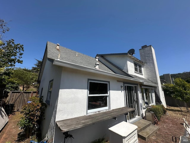17 Sonora Way, Corte Madera, CA 94925 - back of house with stucco siding, roof with shingles, a chimney, and entry steps