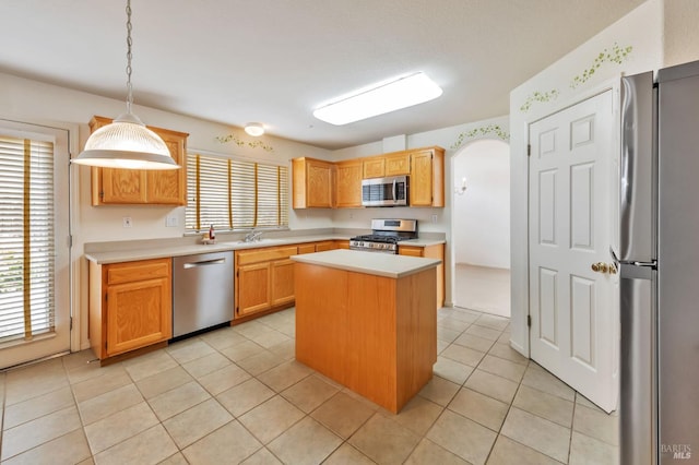 8046 Mason Dr, Rohnert Park, CA 94928 - kitchen featuring stainless steel appliances, light countertops, a kitchen island, pendant lighting, and light tile patterned floors