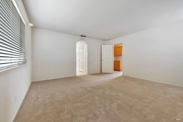 8046 Mason Dr, Rohnert Park, CA 94928 - unfurnished room featuring arched walkways, light colored carpet, and baseboards