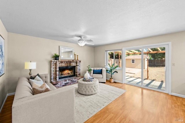 431 Inverness Way, Vacaville, CA 95687 - living area with baseboards, a fireplace, wood finished floors, a textured ceiling, and ceiling fan