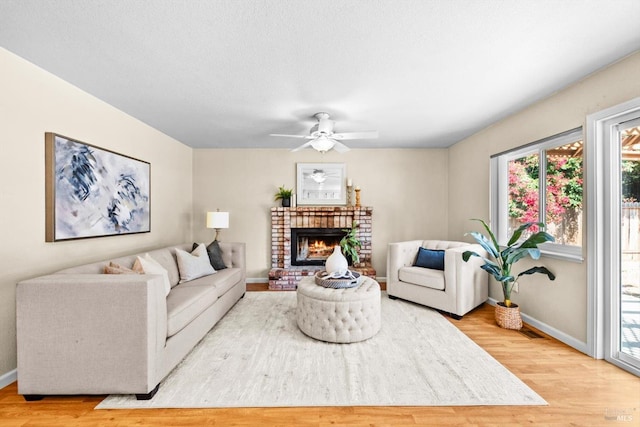 431 Inverness Way, Vacaville, CA 95687 - living room with wood finished floors, baseboards, a brick fireplace, and a ceiling fan