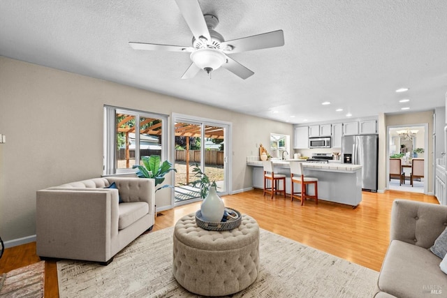 431 Inverness Way, Vacaville, CA 95687 - living area featuring plenty of natural light, light wood-type flooring, ceiling fan, a textured ceiling, and recessed lighting
