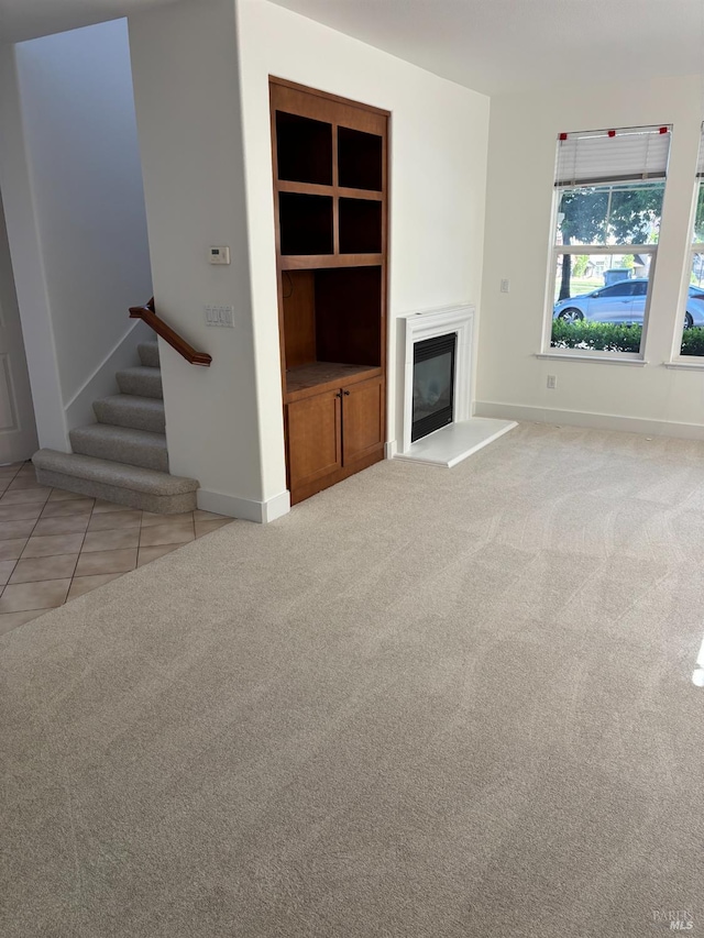 5 Sequoia Rd, San Rafael, CA 94903 - unfurnished living room with a glass covered fireplace, stairway, carpet floors, and tile patterned floors