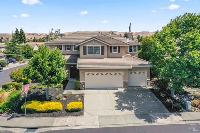 473 Mccall Dr, Benicia, CA 94510 - traditional-style home featuring stucco siding, a garage, stone siding, a tile roof, and driveway