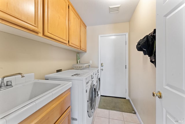 473 Mccall Dr, Benicia, CA 94510 - laundry area with cabinet space, washing machine and dryer, light tile patterned flooring, and baseboards