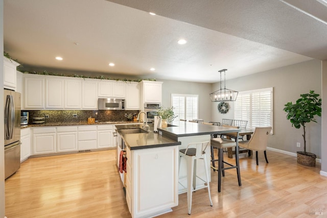 1238 Darling St, Napa, CA 94558 - kitchen with stainless steel appliances, dark countertops, light wood-style flooring, and recessed lighting