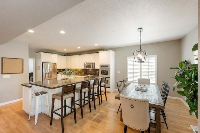 1238 Darling St, Napa, CA 94558 - kitchen featuring appliances with stainless steel finishes, a spacious island, decorative backsplash, light wood-style floors, and recessed lighting
