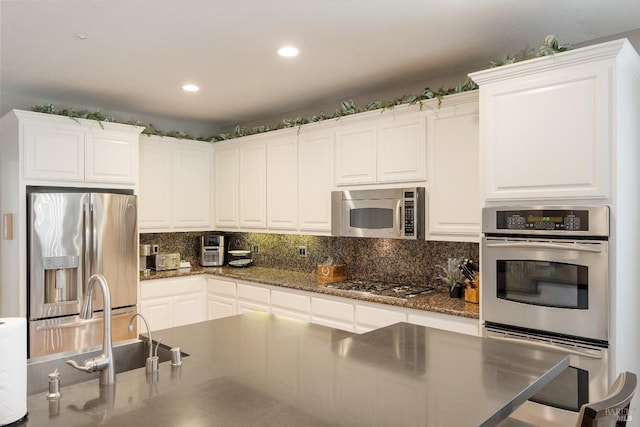 1238 Darling St, Napa, CA 94558 - kitchen with appliances with stainless steel finishes, backsplash, white cabinetry, recessed lighting, and dark stone countertops