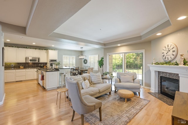 1238 Darling St, Napa, CA 94558 - living area with a tray ceiling, ornamental molding, recessed lighting, light wood-style flooring, and plenty of natural light