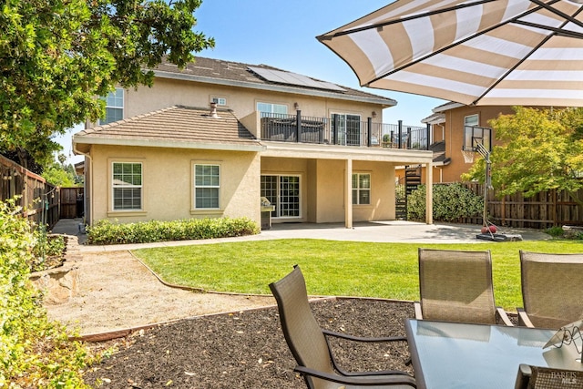 1238 Darling St, Napa, CA 94558 - back of house with a patio area, stucco siding, roof mounted solar panels, a fenced backyard, and a balcony