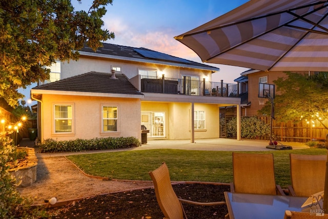 1238 Darling St, Napa, CA 94558 - back of house at dusk featuring a balcony, a patio, roof mounted solar panels, and stucco siding