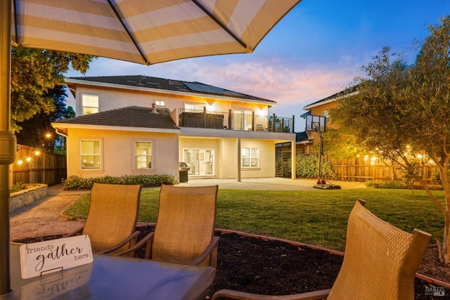 1238 Darling St, Napa, CA 94558 - back of property at dusk featuring a balcony, a patio area, and stucco siding