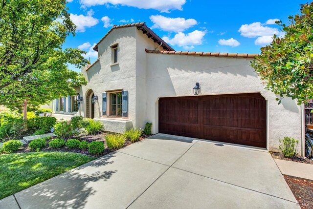 2986 Pebble Beach Cir, Fairfield, CA 94534 - mediterranean / spanish house featuring a garage, stucco siding, and concrete driveway