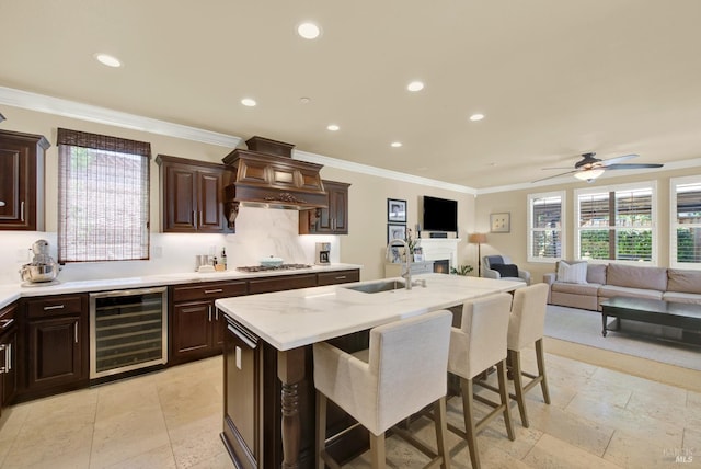 2986 Pebble Beach Cir, Fairfield, CA 94534 - kitchen featuring wine cooler, a sink, a breakfast bar area, stainless steel gas stovetop, and ceiling fan