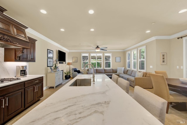 2986 Pebble Beach Cir, Fairfield, CA 94534 - kitchen with a sink, recessed lighting, a ceiling fan, crown molding, and dark brown cabinetry