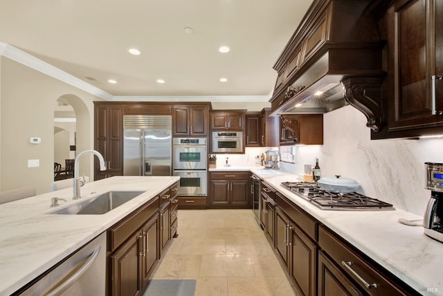 2986 Pebble Beach Cir, Fairfield, CA 94534 - kitchen featuring appliances with stainless steel finishes, a sink, crown molding, arched walkways, and dark brown cabinetry