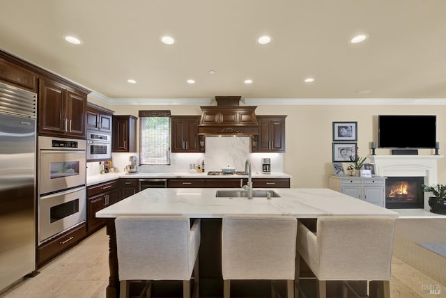 2986 Pebble Beach Cir, Fairfield, CA 94534 - kitchen featuring a sink, appliances with stainless steel finishes, custom range hood, a breakfast bar area, and crown molding