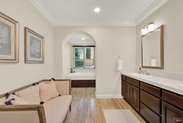 2986 Pebble Beach Cir, Fairfield, CA 94534 - bathroom featuring a garden tub, crown molding, wood finished floors, double vanity, and baseboards