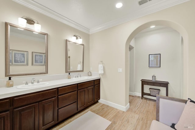 2986 Pebble Beach Cir, Fairfield, CA 94534 - bathroom with wood finished floors, double vanity, ornamental molding, baseboards, and recessed lighting