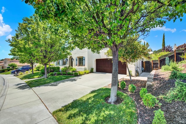 2986 Pebble Beach Cir, Fairfield, CA 94534 - view of property hidden behind natural elements featuring driveway, stucco siding, a garage, and a gate