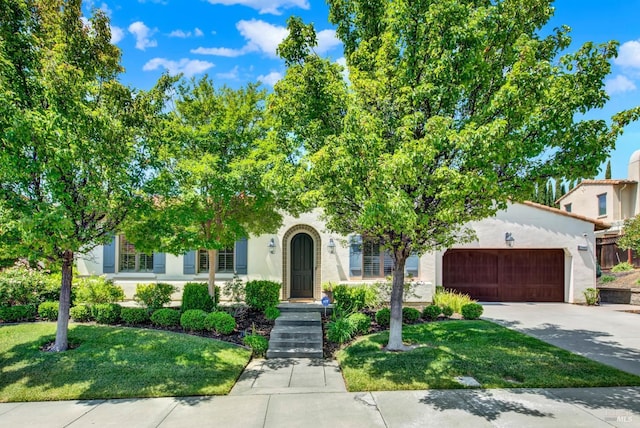 2986 Pebble Beach Cir, Fairfield, CA 94534 - view of property hidden behind natural elements featuring concrete driveway, an attached garage, a front yard, and stucco siding