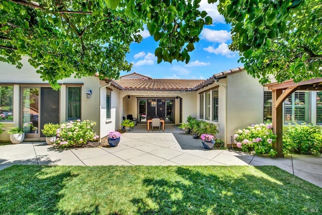 2986 Pebble Beach Cir, Fairfield, CA 94534 - back of house featuring stucco siding, a patio, a lawn, and a tile roof