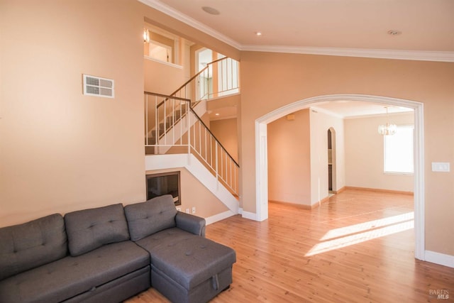 1205 Rosebriar Way, San Jose, CA 95131 - unfurnished living room with crown molding, arched walkways, light wood-style floors, stairs, and a chandelier