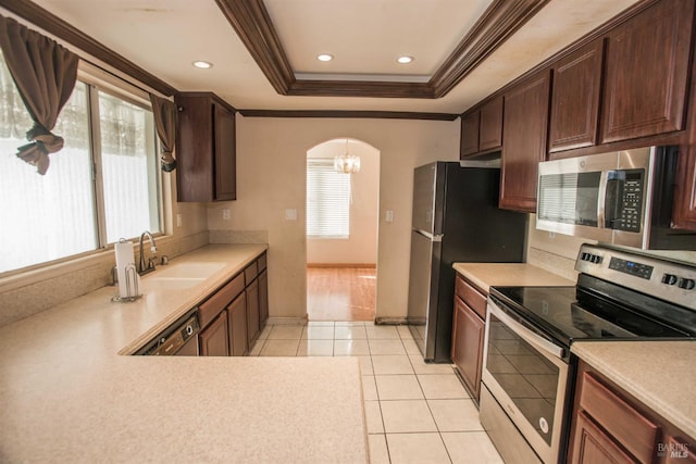 1205 Rosebriar Way, San Jose, CA 95131 - kitchen with stainless steel appliances, ornamental molding, a tray ceiling, light countertops, and arched walkways