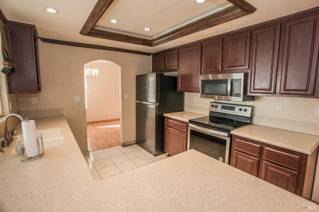 1205 Rosebriar Way, San Jose, CA 95131 - kitchen with stainless steel appliances, crown molding, arched walkways, a tray ceiling, and light countertops