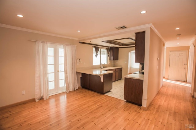 1205 Rosebriar Way, San Jose, CA 95131 - kitchen featuring ornamental molding, light wood finished floors, light countertops, arched walkways, and recessed lighting