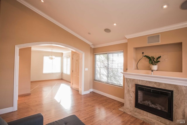 1205 Rosebriar Way, San Jose, CA 95131 - unfurnished living room with arched walkways, wood finished floors, ornamental molding, a chandelier, and a premium fireplace