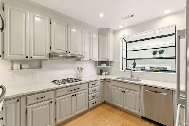 1572 Vista St, Oakland, CA 94602 - kitchen with appliances with stainless steel finishes, under cabinet range hood, light countertops, tasteful backsplash, and recessed lighting