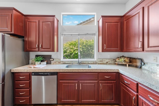 2832 Parkview Ter, Fairfield, CA 94534 - kitchen featuring stainless steel appliances, a sink, reddish brown cabinets, and light stone counters