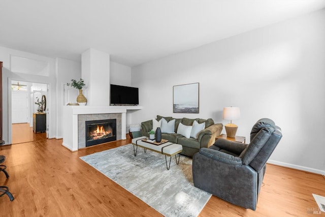 2832 Parkview Ter, Fairfield, CA 94534 - living room featuring wood finished floors, a tiled fireplace, and baseboards