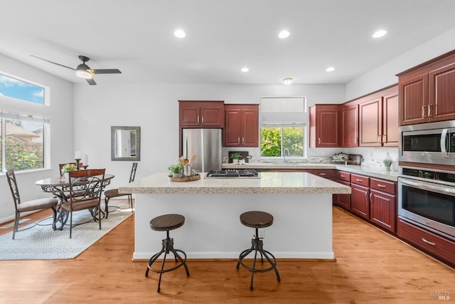 2832 Parkview Ter, Fairfield, CA 94534 - kitchen featuring stainless steel appliances, a kitchen bar, a center island, light wood-style flooring, and recessed lighting