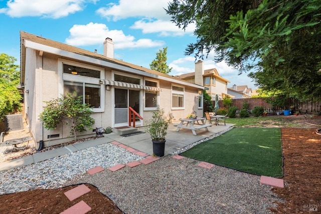 2832 Parkview Ter, Fairfield, CA 94534 - rear view of property with stucco siding, a patio area, entry steps, and a chimney