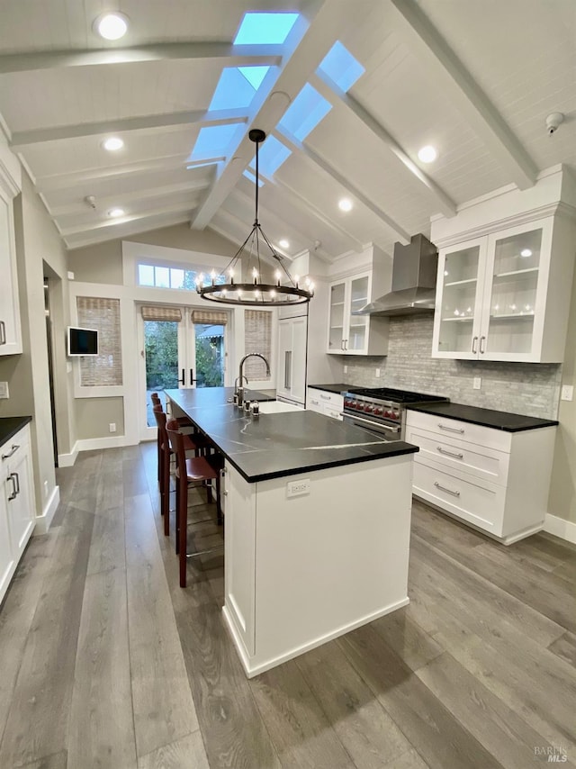 1610 Myrtle St, Calistoga, CA 94515 - kitchen featuring wall chimney range hood, a sink, dark countertops, a chandelier, and baseboards