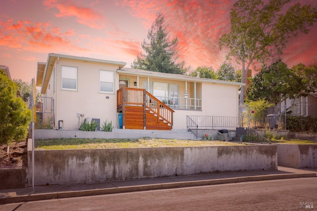7 Fairview Ave, Vallejo, CA 94590 - view of front of house featuring stairway, stucco siding, and covered porch