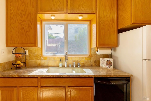 7 Fairview Ave, Vallejo, CA 94590 - kitchen featuring black dishwasher, a sink, freestanding refrigerator, tasteful backsplash, and light stone countertops