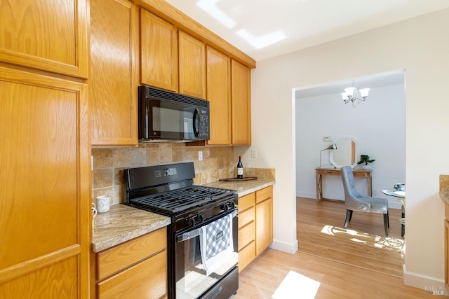 7 Fairview Ave, Vallejo, CA 94590 - kitchen featuring black appliances, tasteful backsplash, light countertops, light wood-style floors, and a chandelier