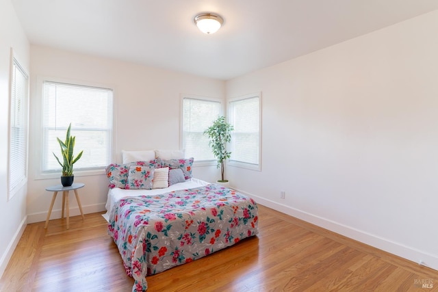 7 Fairview Ave, Vallejo, CA 94590 - bedroom with multiple windows, light wood finished floors, and baseboards