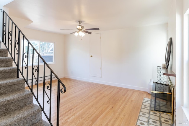 7 Fairview Ave, Vallejo, CA 94590 - stairs featuring wood finished floors, a ceiling fan, baseboards, and a baseboard radiator