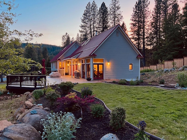 9 Spring Meadows Rd, Mccloud, CA 96507 - back of property at dusk with french doors, a deck, and metal roof