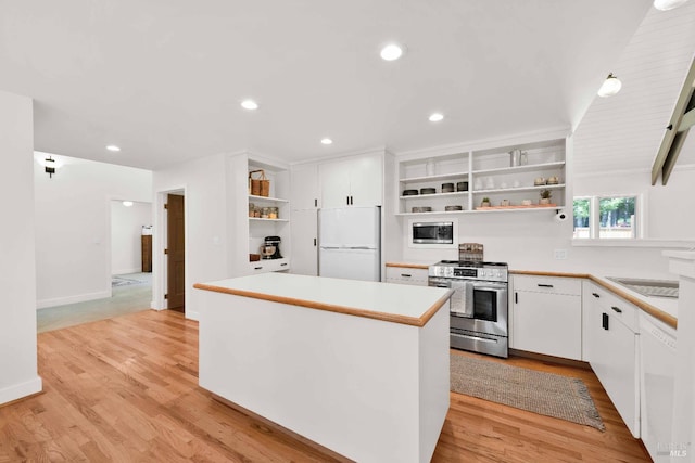 9 Spring Meadows Rd, Mccloud, CA 96507 - kitchen with open shelves, stainless steel appliances, light countertops, white cabinets, and light wood finished floors