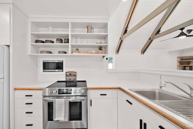 9 Spring Meadows Rd, Mccloud, CA 96507 - kitchen featuring appliances with stainless steel finishes, open shelves, white cabinets, light countertops, and beam ceiling